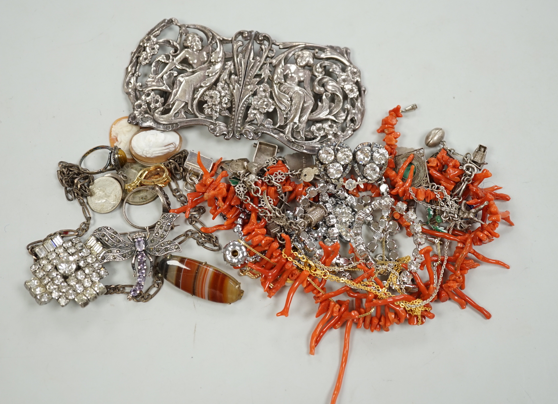 A late Victorian Art Nouveau silver nurses' buckle, William Comyns, London, 1900, 11.9cm and a small group of sundry jewellery including charm bracelet, coral necklace etc.